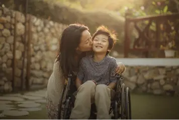 Family caregiver with a child outdoors