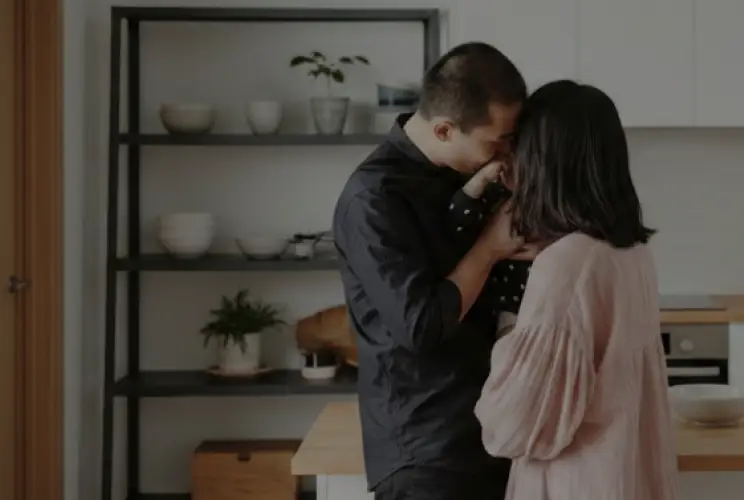 Couple hugging their son
